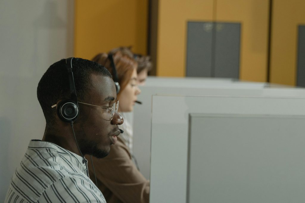 Professional call center agents working in a modern office environment, emphasizing teamwork and customer support.